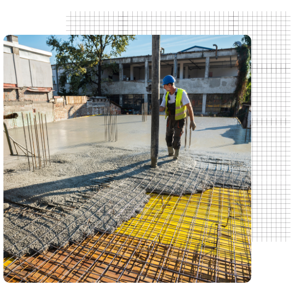 Construction worker pouring and leveling concrete on a reinforced structure